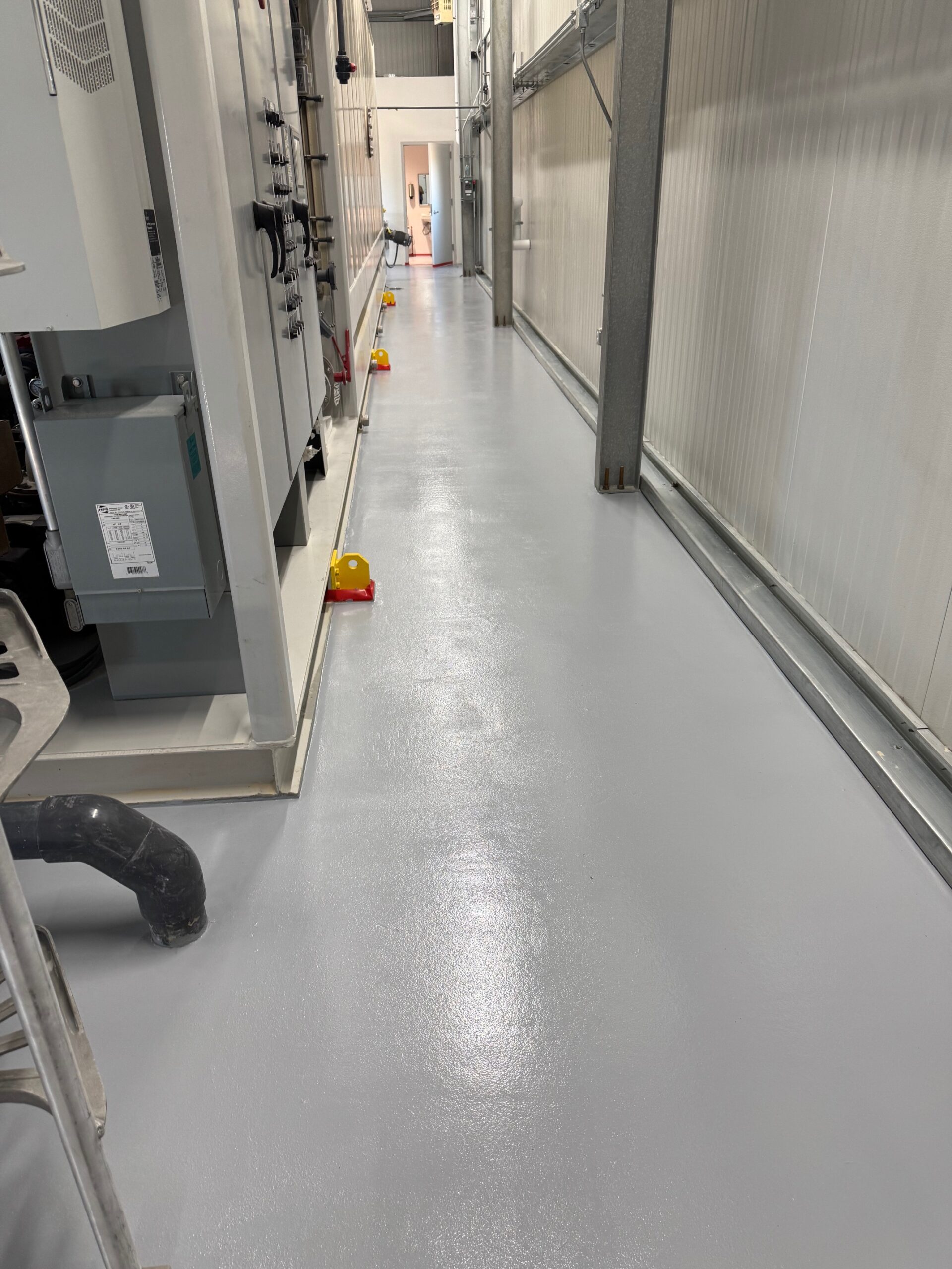 A clean, gray novolac epoxy floor in a chemical processing facility.