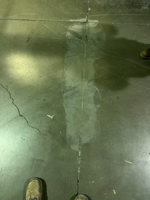 A close-up view of a repaired concrete floor showing resurfacing work. — commercial concrete floor installation guide
