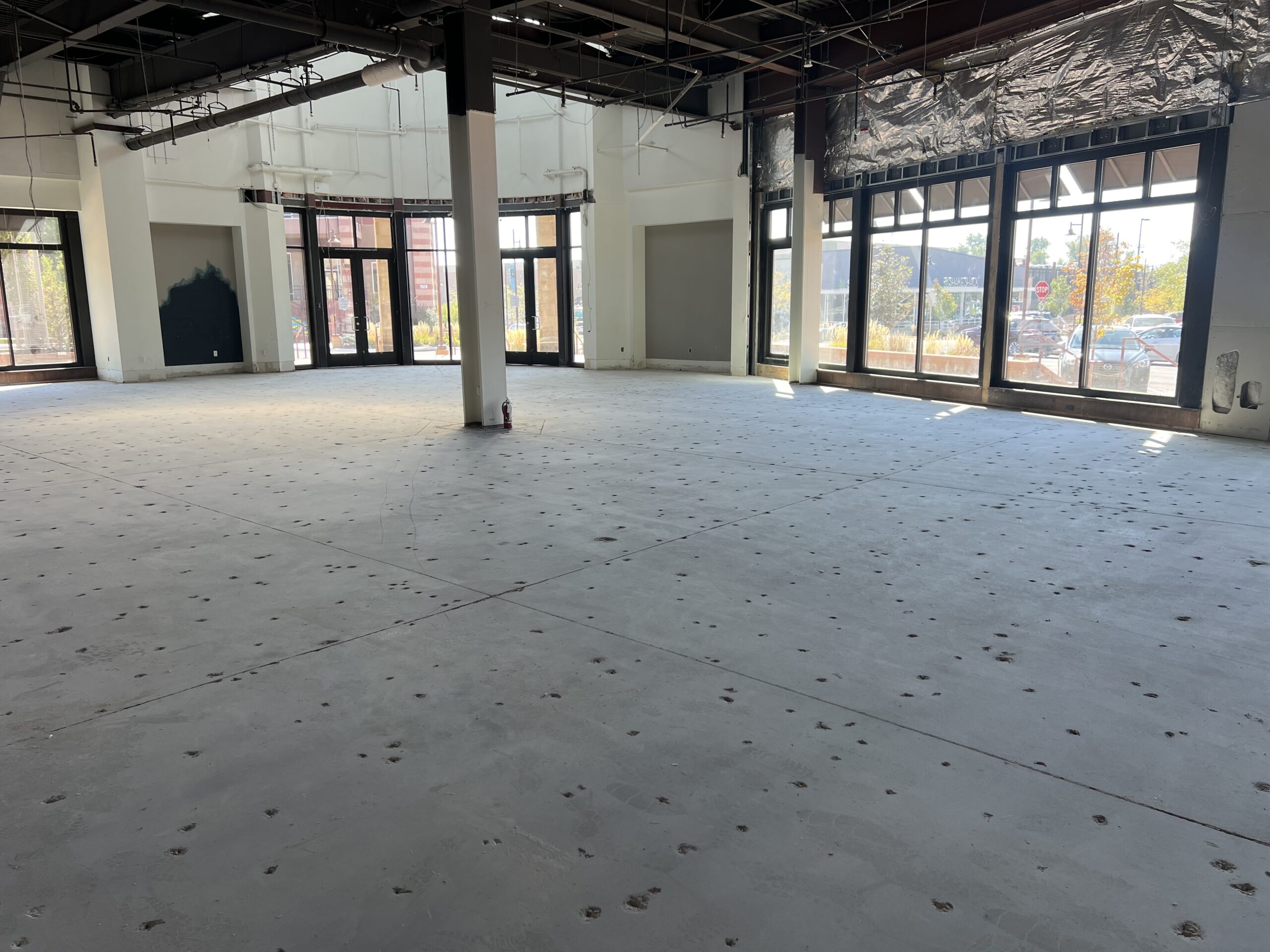 Interior view of a space with ground concrete floor during the grind and seal process. — commercial concrete floor installation guide