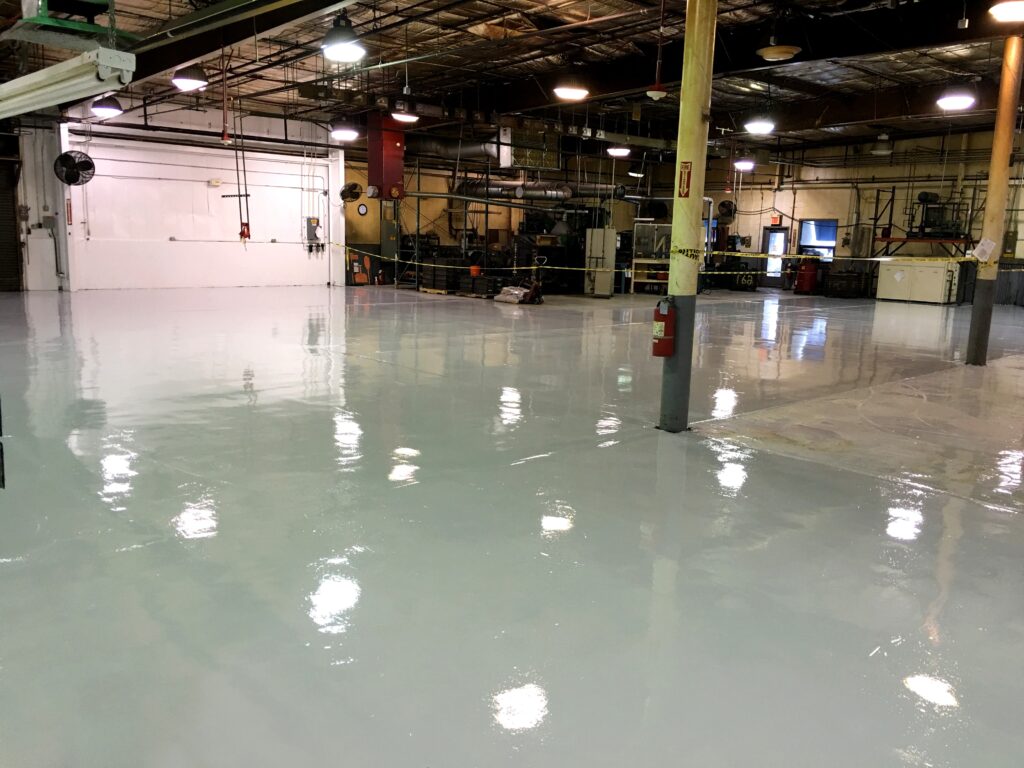 A large industrial space with a newly finished epoxy floor.