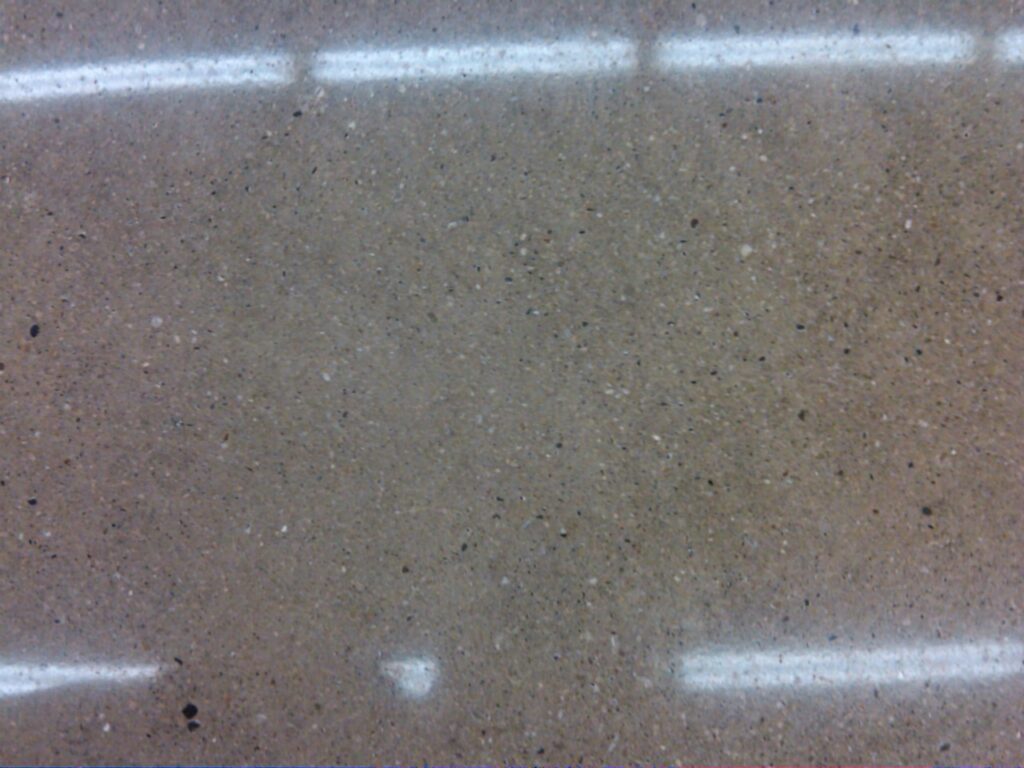 Close-up view of a sand finished polished concrete surface.