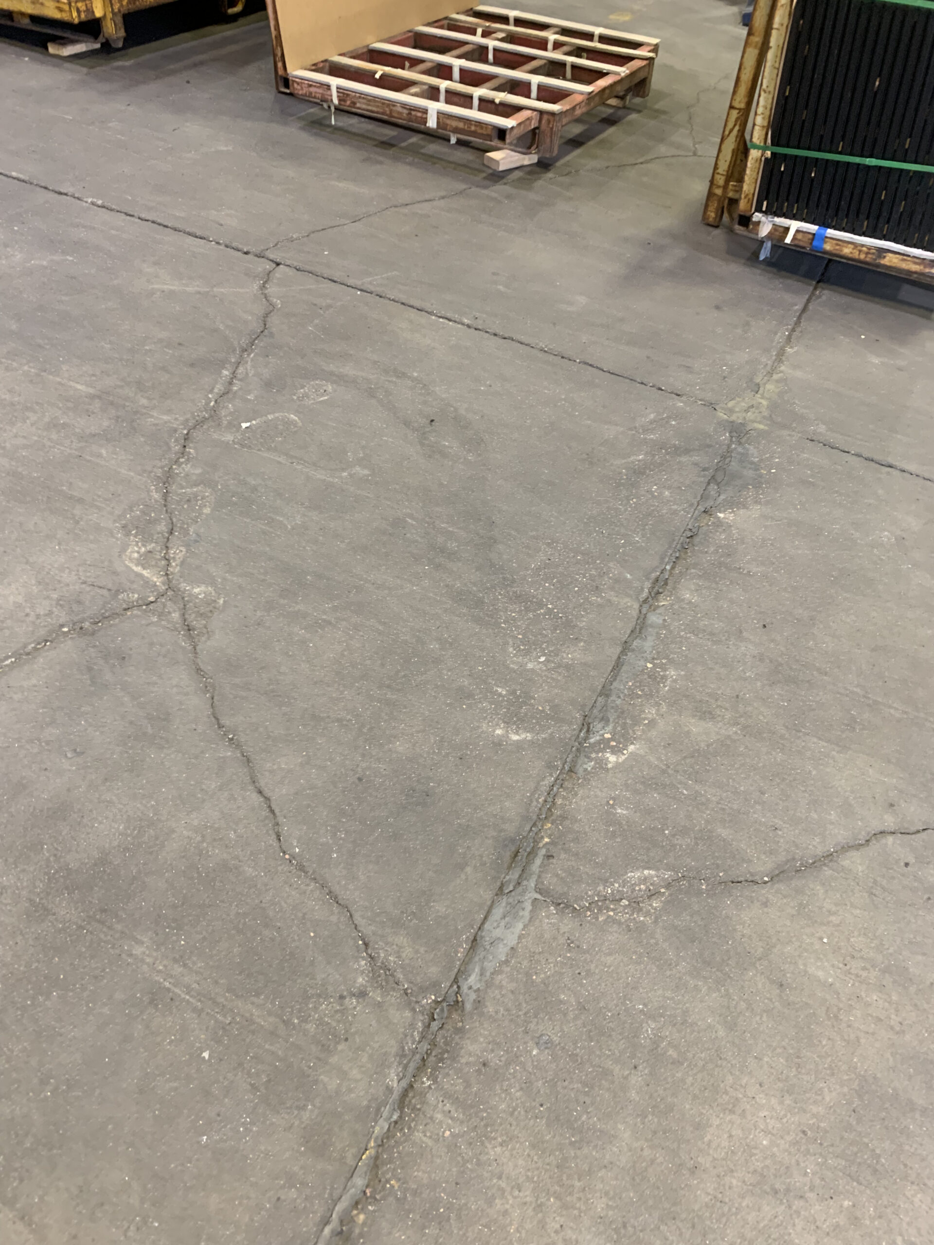 Concrete floor showing surface wear before resurfacing.
