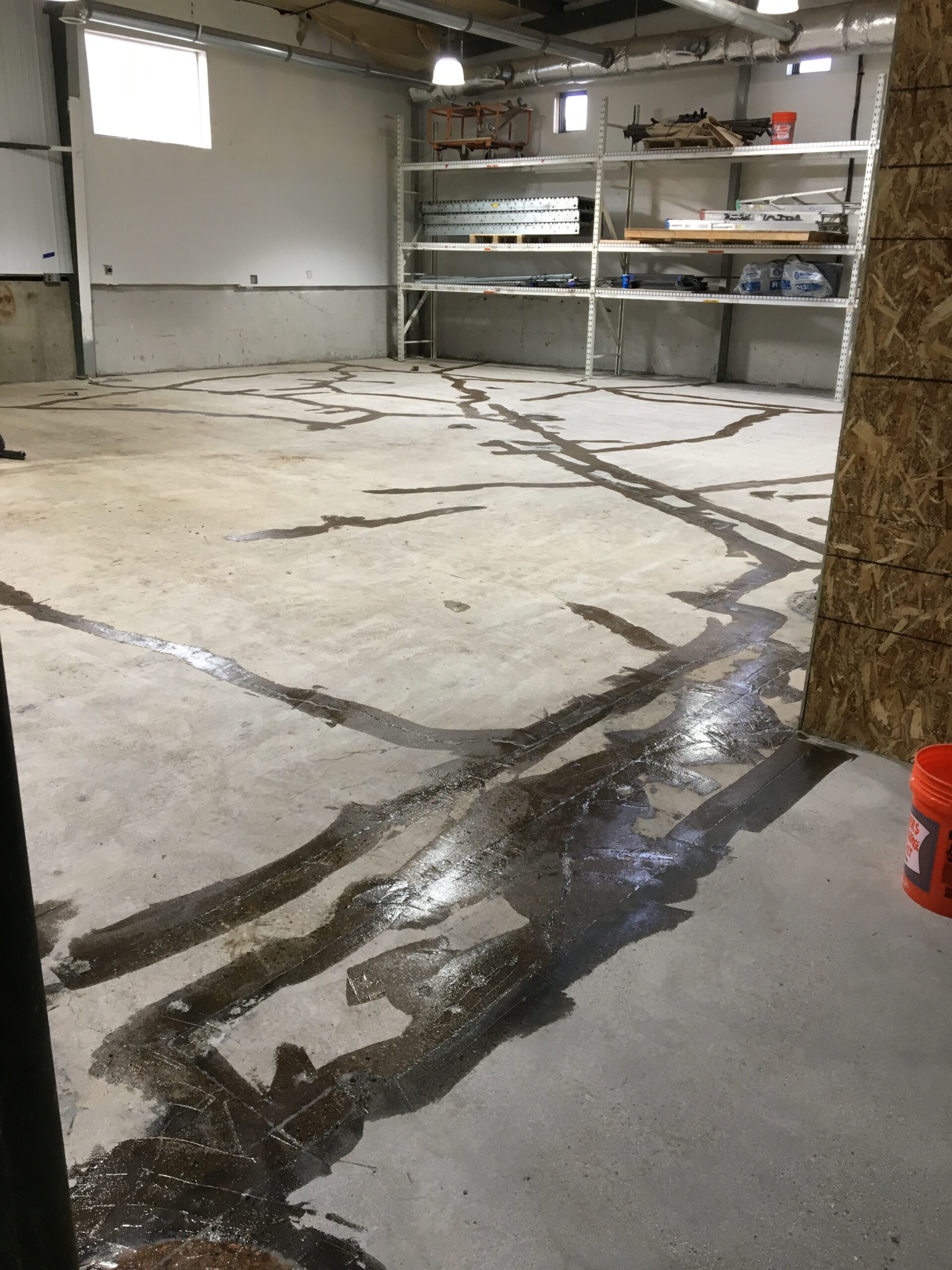Wide shot of a warehouse shop area before epoxy floor surface preparation.