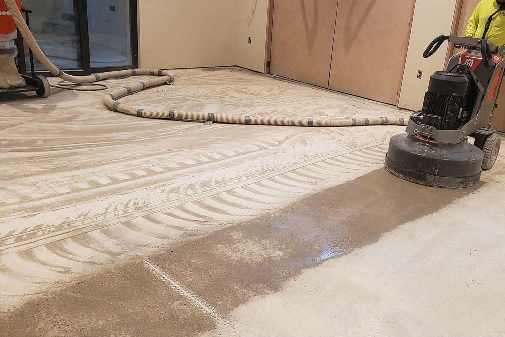 Concrete grinding work in a commercial facility.