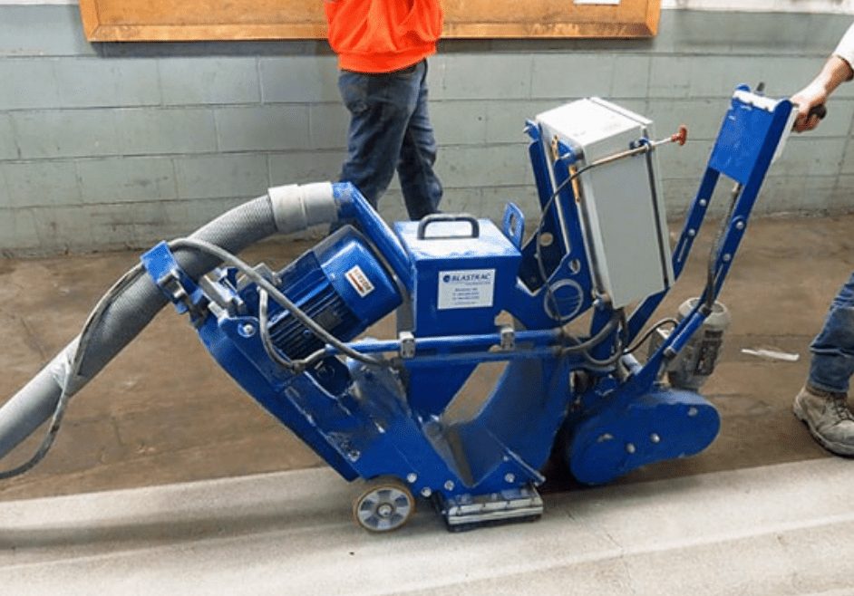 Concrete surface preparation using shot blasting in a commercial facility.