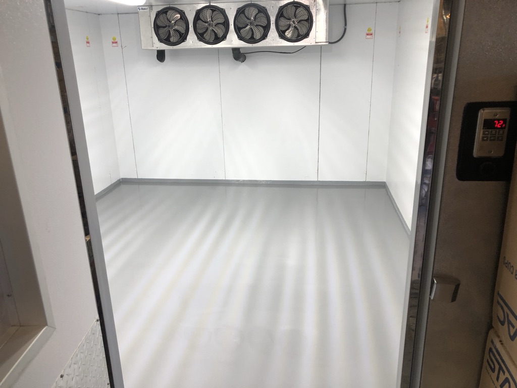 Industrial facility with floor coating installation in progress